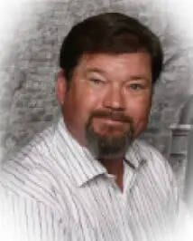 headshot of man with a beard and mustache